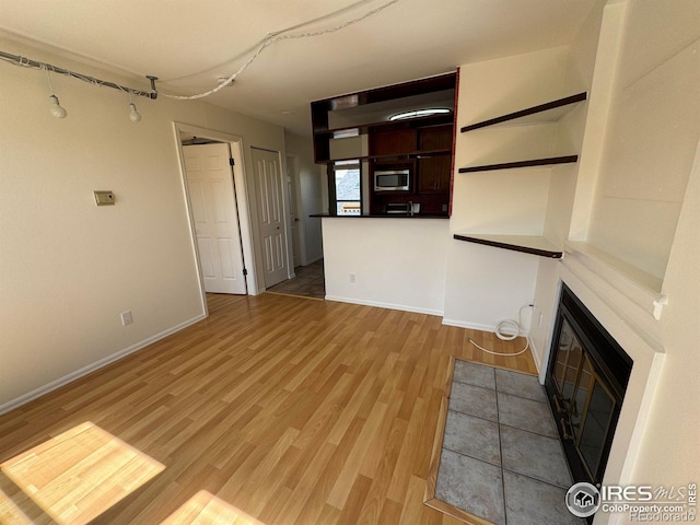 3025 Broadway St Unit 17, Boulder, CO 80304 - unfurnished living room with a tile fireplace and light wood finished floors