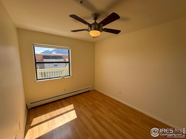 3025 Broadway St Unit 17, Boulder, CO 80304 - unfurnished room with a baseboard heating unit, wood finished floors, and a ceiling fan