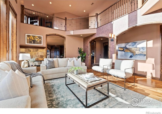 1740 N Ridge Ln, Estes Park, CO 80517 - living room with arched walkways, wood finished floors, a towering ceiling, and recessed lighting
