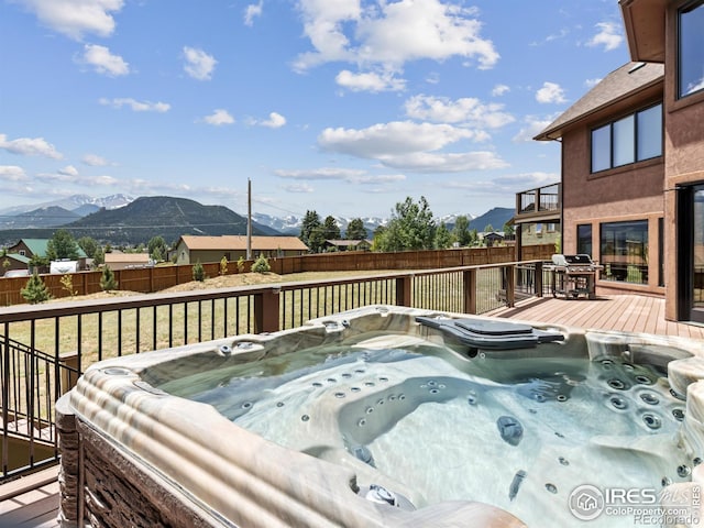 1740 N Ridge Ln, Estes Park, CO 80517 - wooden deck featuring a hot tub, a fenced backyard, and a mountain view