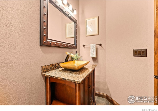 1740 N Ridge Ln, Estes Park, CO 80517 - bathroom featuring vanity and a textured wall