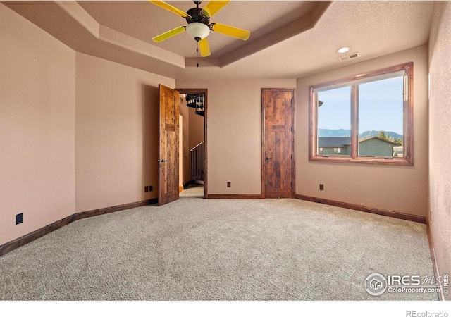 1740 N Ridge Ln, Estes Park, CO 80517 - carpeted empty room with a tray ceiling and ceiling fan