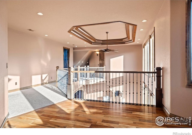 1740 N Ridge Ln, Estes Park, CO 80517 - hallway with wood finished floors, a tray ceiling, recessed lighting, and an upstairs landing