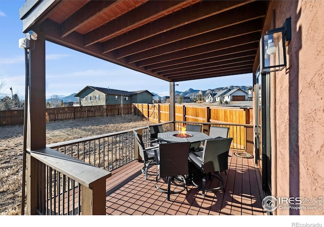1740 N Ridge Ln, Estes Park, CO 80517 - deck with an outdoor fire pit, a fenced backyard, a residential view, and a mountain view