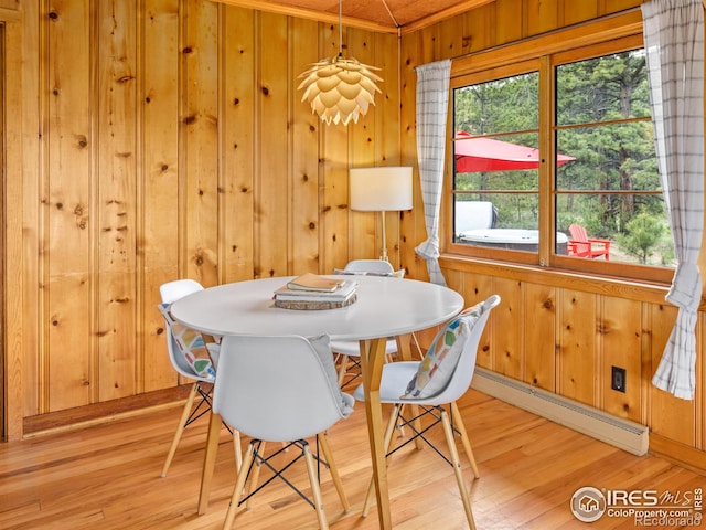 1650 Powelly Ln, Estes Park, CO 80517 - dining area featuring a baseboard heating unit, light wood-style flooring, and wooden walls