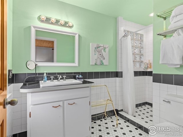 1650 Powelly Ln, Estes Park, CO 80517 - full bathroom with tile walls, vanity, tiled shower, a wainscoted wall, and tile patterned floors