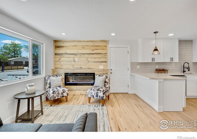 7826 Joan Dr, Denver, CO 80221 - living area featuring light wood-style floors, recessed lighting, and a glass covered fireplace