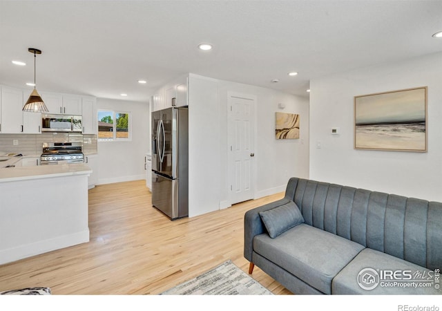 7826 Joan Dr, Denver, CO 80221 - living room featuring light wood-style floors and recessed lighting