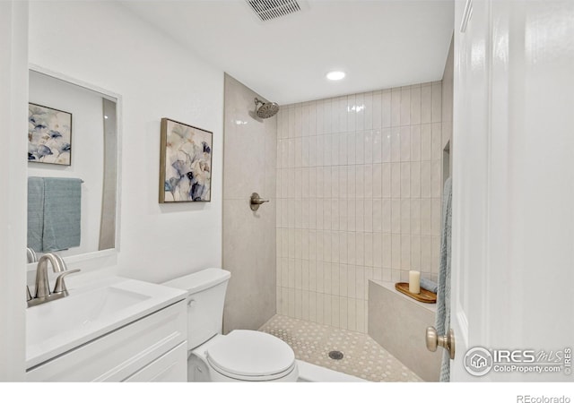 7826 Joan Dr, Denver, CO 80221 - bathroom with a tile shower, vanity, and recessed lighting