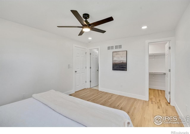 7826 Joan Dr, Denver, CO 80221 - bedroom with recessed lighting, wood finished floors, a walk in closet, ceiling fan, and a closet