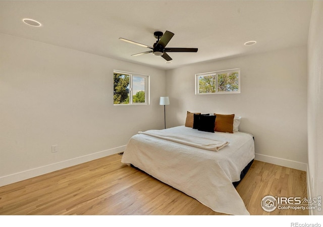 7826 Joan Dr, Denver, CO 80221 - bedroom featuring multiple windows, wood finished floors, and ceiling fan