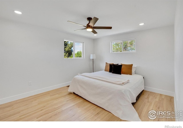 7826 Joan Dr, Denver, CO 80221 - bedroom with multiple windows, wood finished floors, recessed lighting, and ceiling fan