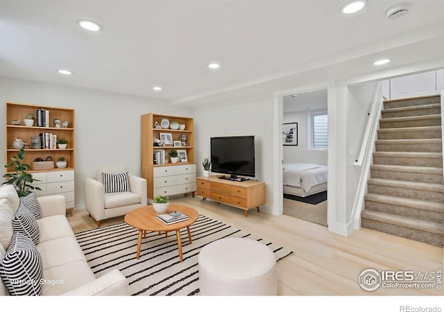 7826 Joan Dr, Denver, CO 80221 - living room featuring light wood-style flooring, stairs, and recessed lighting