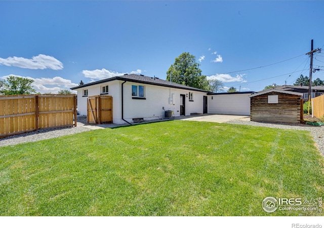 7826 Joan Dr, Denver, CO 80221 - back of property with a patio, stucco siding, and a storage unit