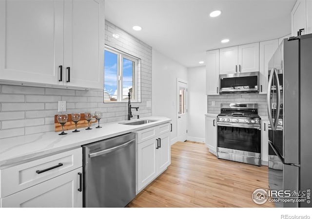 9230 Aspen Dr, Thornton, CO 80229 - kitchen with appliances with stainless steel finishes, tasteful backsplash, white cabinetry, and recessed lighting