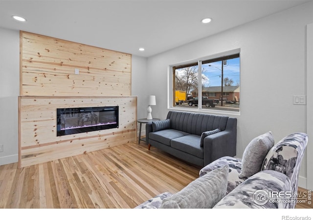 9230 Aspen Dr, Thornton, CO 80229 - living area featuring wood finished floors, recessed lighting, and a glass covered fireplace