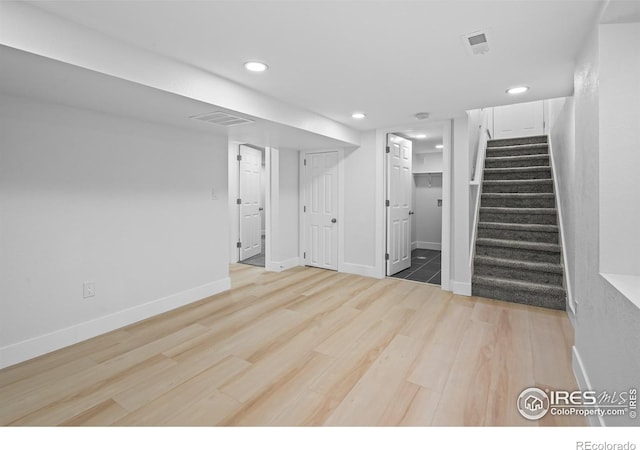 9230 Aspen Dr, Thornton, CO 80229 - unfurnished living room featuring stairs, recessed lighting, and wood finished floors