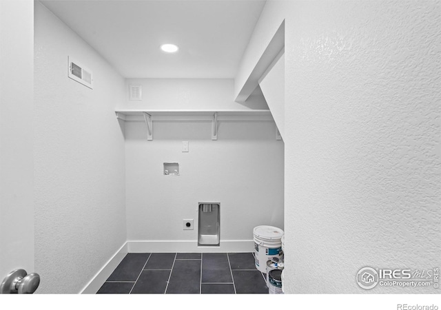 9230 Aspen Dr, Thornton, CO 80229 - washroom featuring washer hookup and dark tile patterned floors