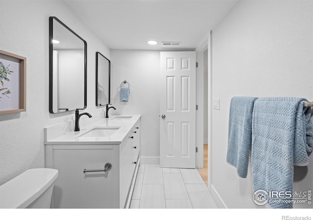 9230 Aspen Dr, Thornton, CO 80229 - bathroom with double vanity, tile patterned floors, and recessed lighting