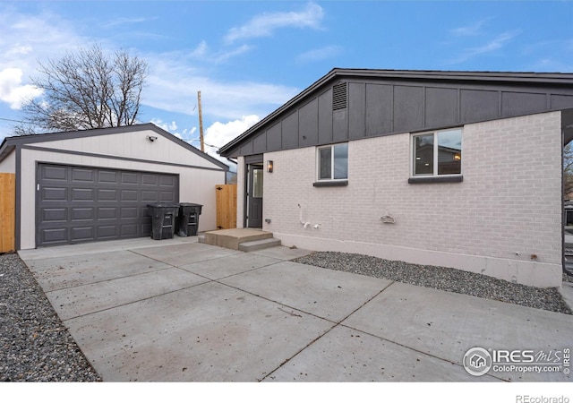 9230 Aspen Dr, Thornton, CO 80229 - back of property with an outbuilding, brick siding, a garage, and concrete driveway