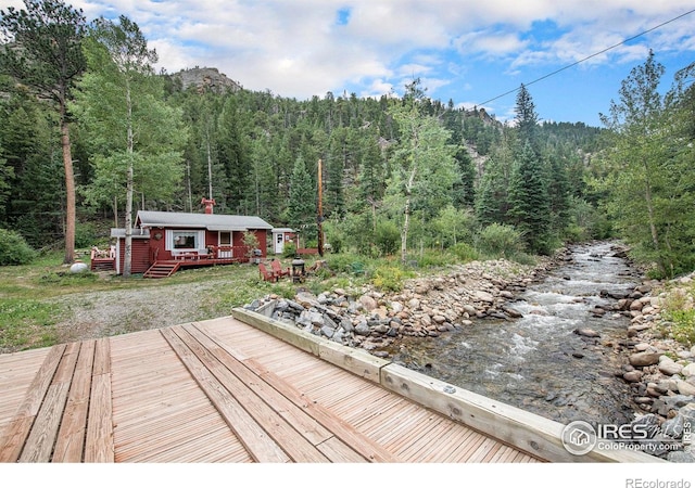 2763 Riverside Dr, Lyons, CO 80540 - wooden deck with a view of trees