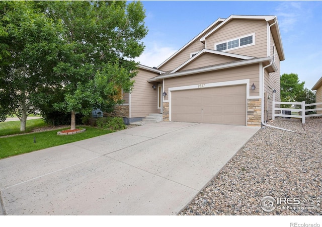 2327 Sunbury Ln, Fort Collins, CO 80524 - view of front facade featuring concrete driveway, stone siding, and an attached garage