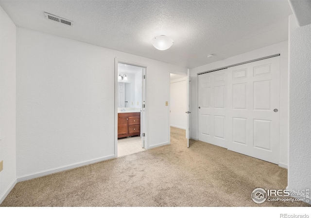 2327 Sunbury Ln, Fort Collins, CO 80524 - unfurnished bedroom featuring carpet flooring, a textured ceiling, a closet, and ensuite bathroom