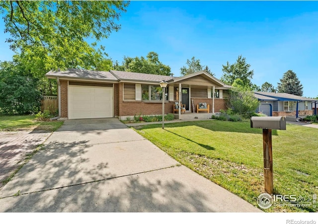 7423 Saulsbury St, Arvada, CO 80003 - ranch-style house with brick siding, an attached garage, a front yard, and driveway