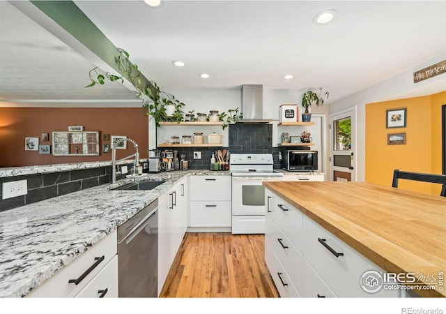 7423 Saulsbury St, Arvada, CO 80003 - kitchen with electric stove, wall chimney exhaust hood, dishwasher, open shelves, and white cabinetry