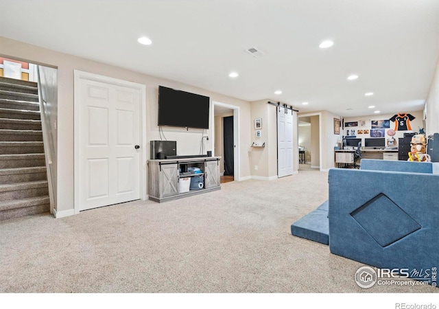 7423 Saulsbury St, Arvada, CO 80003 - living area with carpet flooring, a barn door, stairs, and recessed lighting