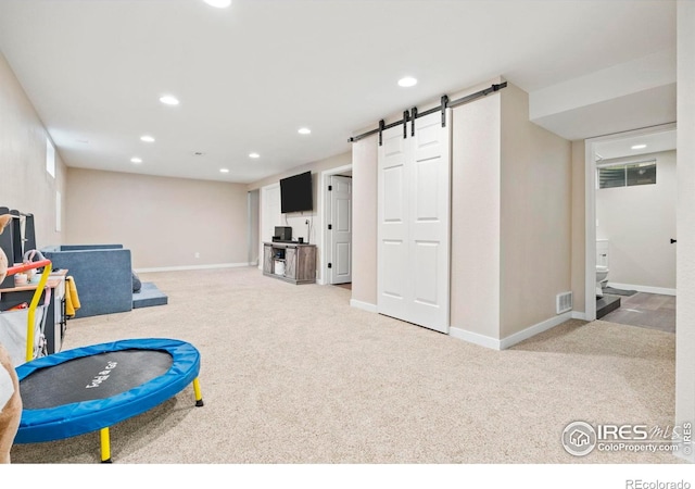 7423 Saulsbury St, Arvada, CO 80003 - playroom featuring carpet flooring, a barn door, and recessed lighting