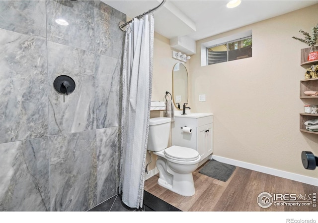 7423 Saulsbury St, Arvada, CO 80003 - full bath with wood finished floors, vanity, and a shower with shower curtain