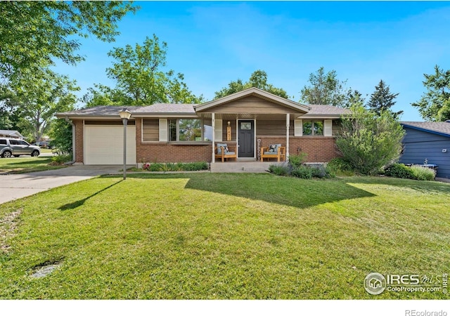 7423 Saulsbury St, Arvada, CO 80003 - single story home featuring brick siding, an attached garage, concrete driveway, and a front yard