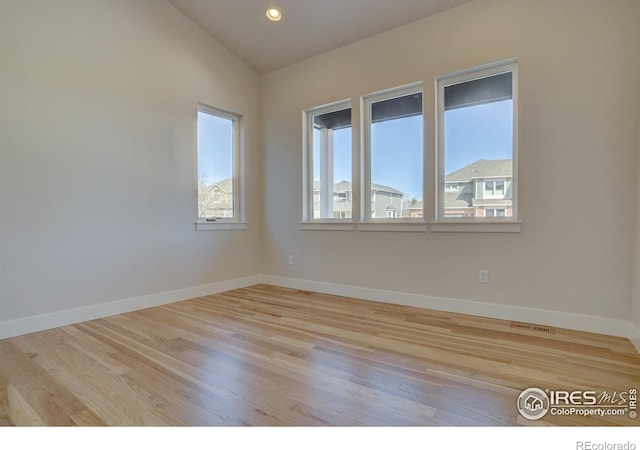 961 Eldorado Ln, Louisville, CO 80027 - spare room featuring wood finished floors, lofted ceiling, and recessed lighting