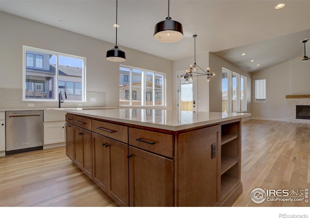 961 Eldorado Ln, Louisville, CO 80027 - kitchen featuring stainless steel dishwasher, light wood finished floors, open floor plan, a chandelier, and a kitchen island