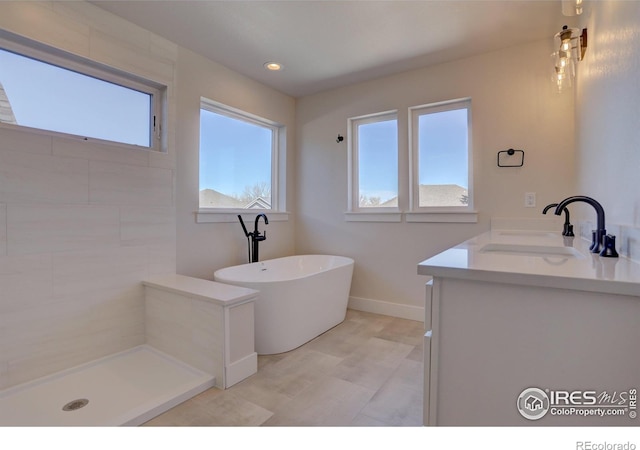 961 Eldorado Ln, Louisville, CO 80027 - bathroom featuring a freestanding bath, double vanity, and recessed lighting
