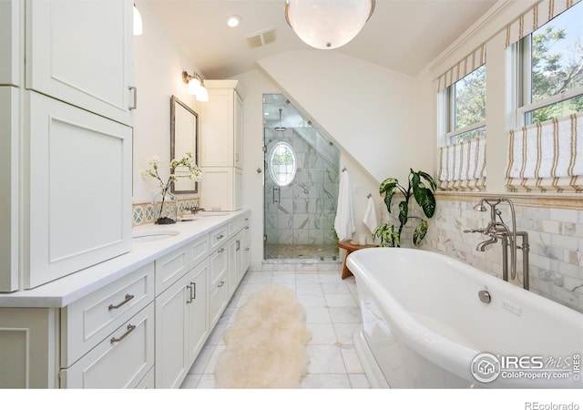 512 Marine St, Boulder, CO 80302 - full bath featuring a freestanding tub, a shower stall, double vanity, vaulted ceiling, and tile patterned flooring