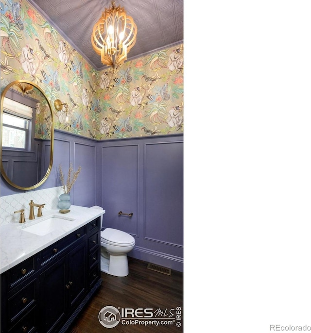512 Marine St, Boulder, CO 80302 - bathroom with a chandelier, vanity, wallpapered walls, a decorative wall, and wood finished floors