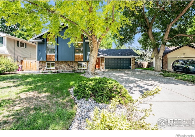 2213 Hiawatha Ct, Fort Collins, CO 80525 - view of front of home featuring stone siding, concrete driveway, and an attached garage