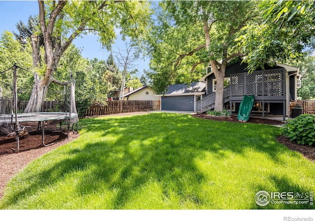 2213 Hiawatha Ct, Fort Collins, CO 80525 - fenced backyard featuring a trampoline, stairs, and a deck