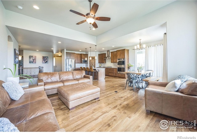 1897 Holloway Dr, Windsor, CO 80550 - living area with light wood-type flooring, a ceiling fan, a chandelier, and recessed lighting