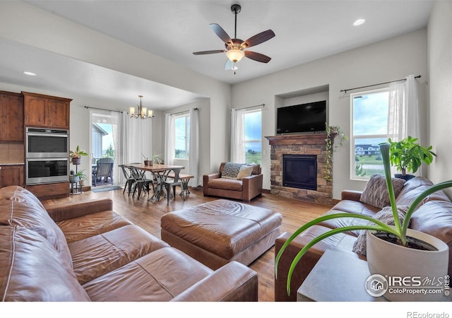 1897 Holloway Dr, Windsor, CO 80550 - living area with a chandelier, light wood-type flooring, a fireplace, a ceiling fan, and recessed lighting