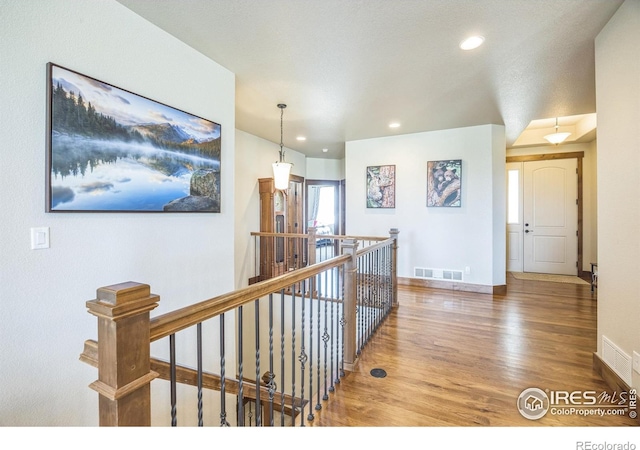 1897 Holloway Dr, Windsor, CO 80550 - hallway featuring wood finished floors, an upstairs landing, and recessed lighting