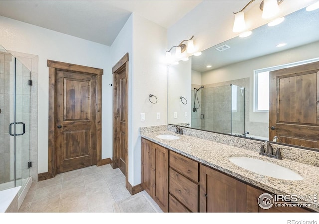 1897 Holloway Dr, Windsor, CO 80550 - full bath featuring a shower stall, double vanity, and tile patterned floors