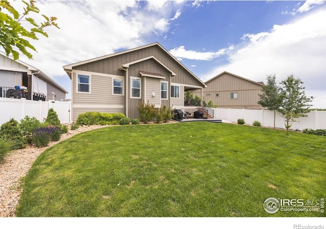 1897 Holloway Dr, Windsor, CO 80550 - view of front of home with board and batten siding and a fenced backyard