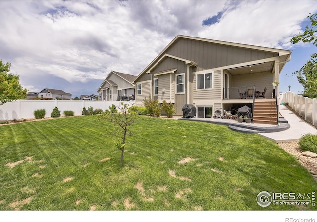 1897 Holloway Dr, Windsor, CO 80550 - back of house featuring a patio, board and batten siding, stairway, and a deck
