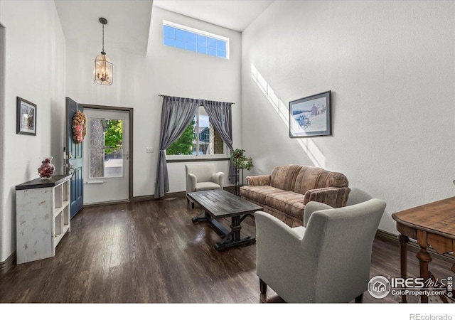 11861 Fairplay St, Commerce City, CO 80603 - living room with wood finished floors, a towering ceiling, and a chandelier