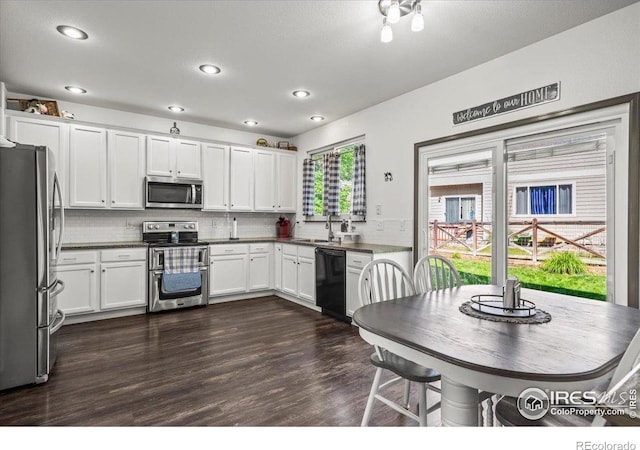 11861 Fairplay St, Commerce City, CO 80603 - kitchen featuring stainless steel appliances, recessed lighting, dark wood-style flooring, dark countertops, and decorative backsplash