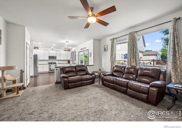 11861 Fairplay St, Commerce City, CO 80603 - living area featuring ceiling fan, dark carpet, and dark wood-style flooring