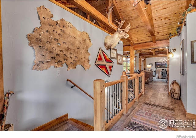 2055 Siskin Dr, Estes Park, CO 80517 - hallway featuring a wooden ceiling with exposed beams, hardwood / wood-style floors, and an upstairs landing